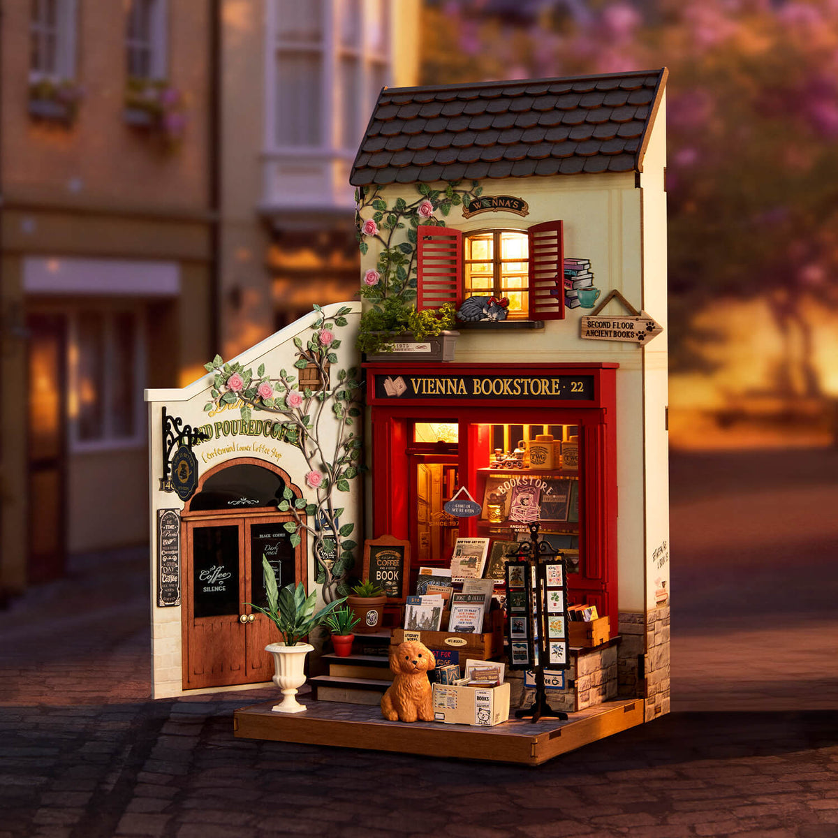
Vienna Bookstore iluminada en una ambientación de calle, con fachada roja y libros en la entrada.