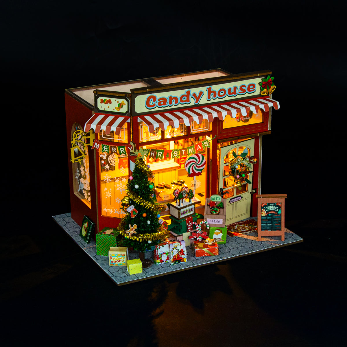 Candy House de Hongda, iluminada sobre fondo oscuro
